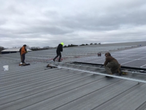 Full Spectrum Solar Installers on the Rooftop of Oregon Ice Arena